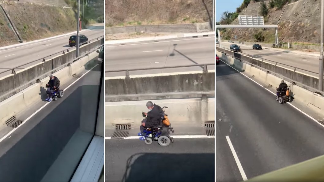 Elderly Man Navigates Electric Wheelchair Along Bustling Hong Kong Highway